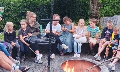 Kindergruppe am Lagerfeuer hört eine biblische Geschichte